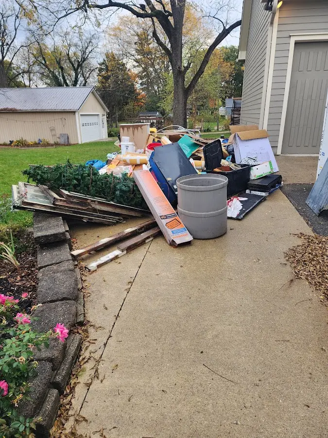Dumpster being loaded with debris for Estate Cleanout Dumpster Rental in Nelsonville